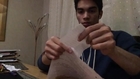 Guy Makes Piece of Paper Roll Across Arms