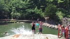 Guy Trips while Jumping into Water with Siblings