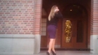 Longhaired blonde lady in black sweater, purple pencil skirt and sky high Mary Jane stiletto pumps